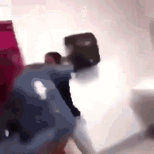 a blurred image of a person holding a suitcase