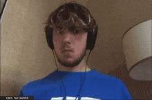 a man wearing headphones has greg the rapper written on the screen