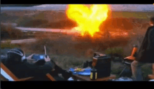 a man is sitting in front of a large explosion