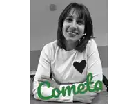 a woman wearing a white sweater with a black heart and the word cometa in green letters