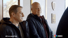two men standing next to each other with the hashtag #chicagofire on the bottom right