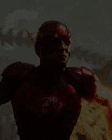 a man in a red superhero costume with a flash logo on his chest
