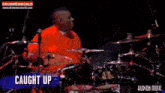 a man is playing drums in front of a drum set with the words hudson music on the bottom
