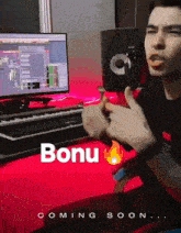 a man is sitting in front of a computer with the word bonu coming soon