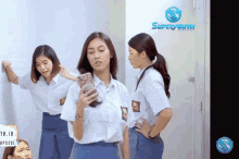 a group of girls are standing in front of a white board with superyouth written on it