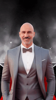 a man in a suit and bow tie is smiling