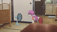 a girl with purple hair looks at a fan in a room