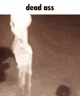 a skeleton is standing in front of a candle with the words `` dead ass '' written above it .