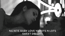 a black and white photo of a man and woman laying in bed with the caption na nite baby love ya lots n lots sweet dreams