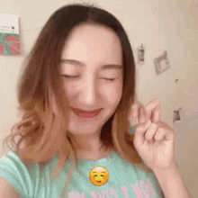 a woman with her eyes closed is wearing a t-shirt that says do n't worry