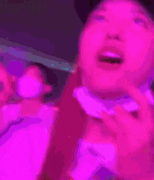 a blurry picture of a person 's face with purple lighting