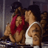 a man in a white tank top has a tattoo on his arm that says pioneer dj