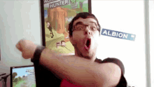 a man is standing in front of a poster that says hunter on it