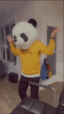 a person dressed as a panda bear wearing a yellow rvca sweater