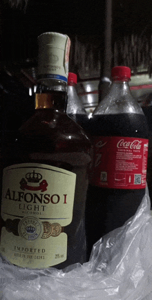 a bottle of alfonso i light next to a bottle of coca cola
