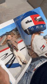 a person is holding a helmet that says tommy on it