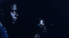 a man is looking at a skeleton with a light shining on it