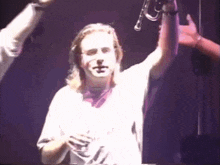 a man in a white shirt is playing a trumpet