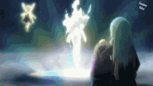 a man and a woman are standing in front of a glowing object .