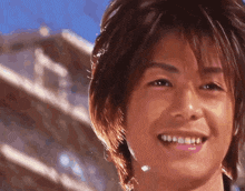 a close up of a young man 's face smiling