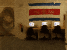 a painting of people sitting in front of computer monitors with the word photo in the bottom right corner