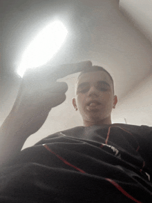 a young man taking a picture of himself with his finger up
