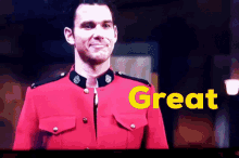 a man in a red uniform is standing in front of a screen that says great