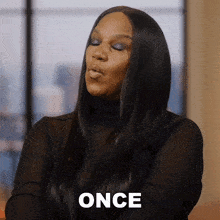 a woman blowing a kiss with the word once written on her face