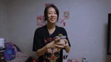 a woman wearing a black shirt that says ard on the front