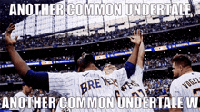 the brewers players are celebrating in front of the crowd