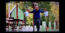 a man is carrying two buckets on his shoulders with a tiktok watermark on the bottom