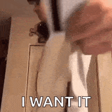 a person is holding a piece of paper that says i want it .