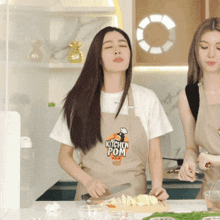 a woman in an apron that says kitchen pom