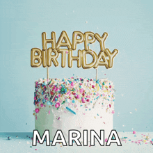 a cake with sprinkles and a happy birthday marina topper