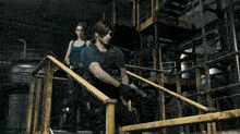 a man and a woman are standing next to each other on stairs holding guns .