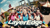 a group of people ride a roller coaster called layer edge