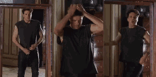 a man in a black shirt is standing in front of a door
