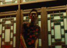 a blurry picture of a person in front of a window