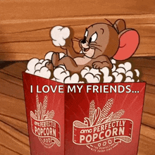 a cartoon mouse is sitting in a bucket of popcorn .