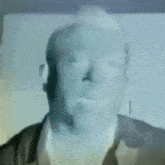 a blurry picture of a man 's face with a blue background