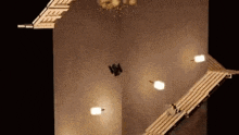 a person is standing on a wooden staircase in a dark room .