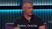 a man in a black shirt with bueno gracias written on his shirt