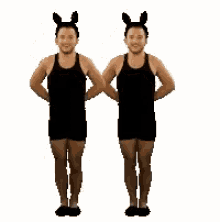 two men are dancing together and wearing bunny ears .