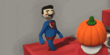 a man in a blue suit stands next to a pumpkin