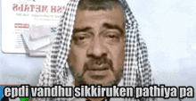 a man with a scarf around his head is crying with a newspaper behind him .