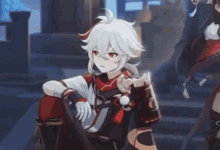 a boy with white hair and red eyes is sitting in a room .