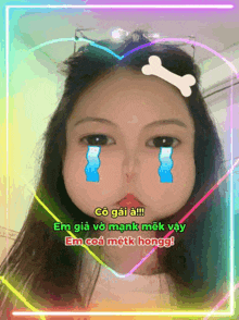 a girl with tears running down her face is surrounded by a heart and a bone