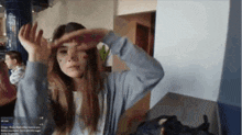 a woman with a tattoo on her face is covering her eyes