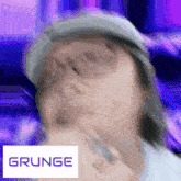 a blurred image of a person with the word grunge behind them