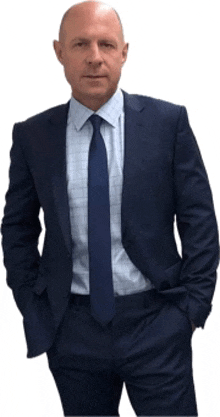 a bald man in a suit and tie stands with his hands in his pockets